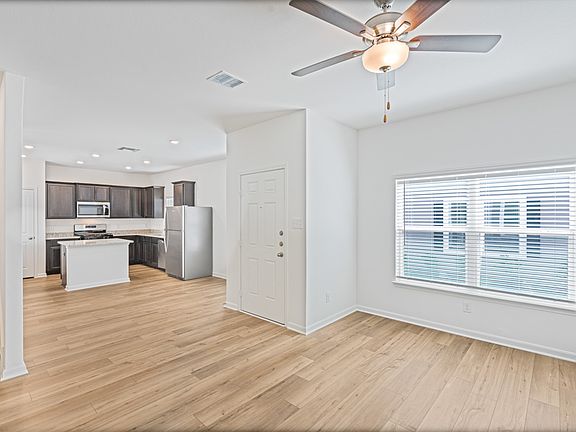 Open layout with a large living room leading into the upgraded kitchen.