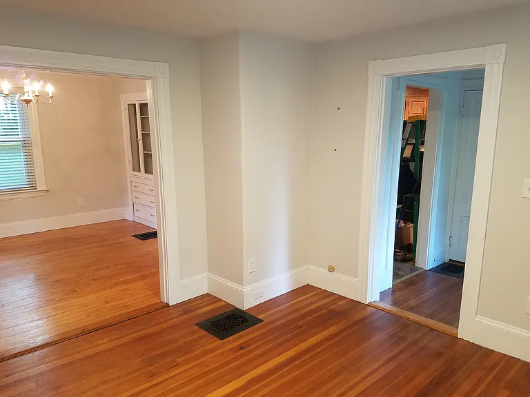 Living room with door to dining room and door to entrance hallway