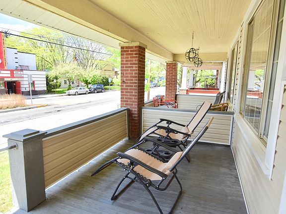 Shaded front porch overlooking a local cat cafe, fitness studio, independent movie theater, and coffee shop