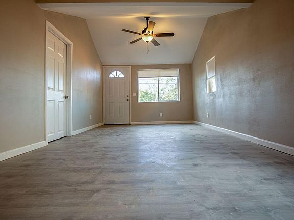 Living room. Wood floors, ceiling fans, vaulted ceiling.