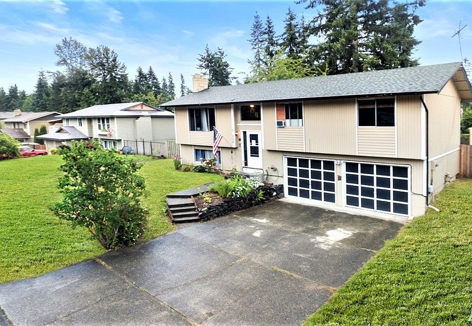 Front view of home with RV parking behind the fence on the right