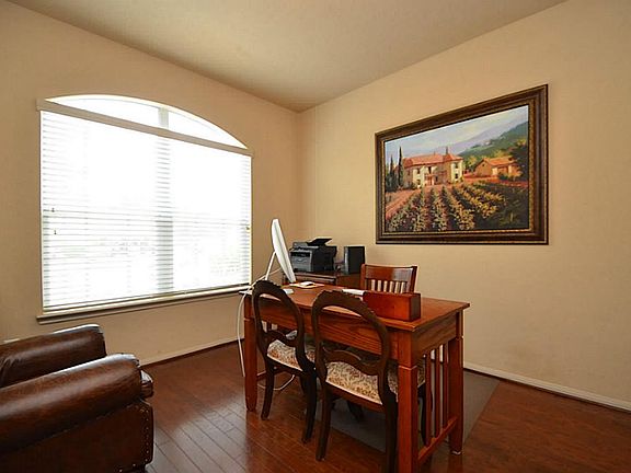 Hard wood floor study has large windows which bring in lots of natural light.