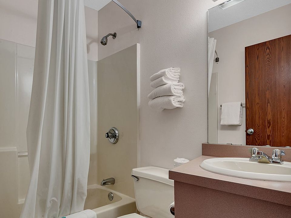 Full bathroom with tub/shower combo, large vanity, and ample storage space.