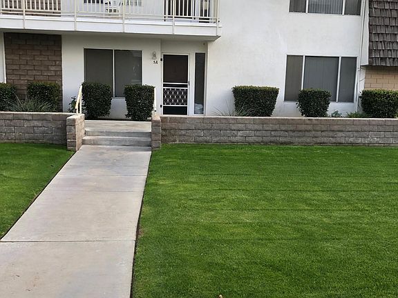 Front of the building------only 6 units on our 2 bedroom side. Lovely grassy area with beautiful trees