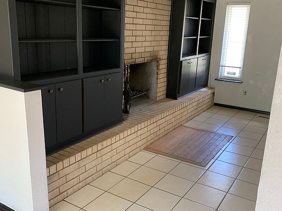 bookcases and fireplace in living area