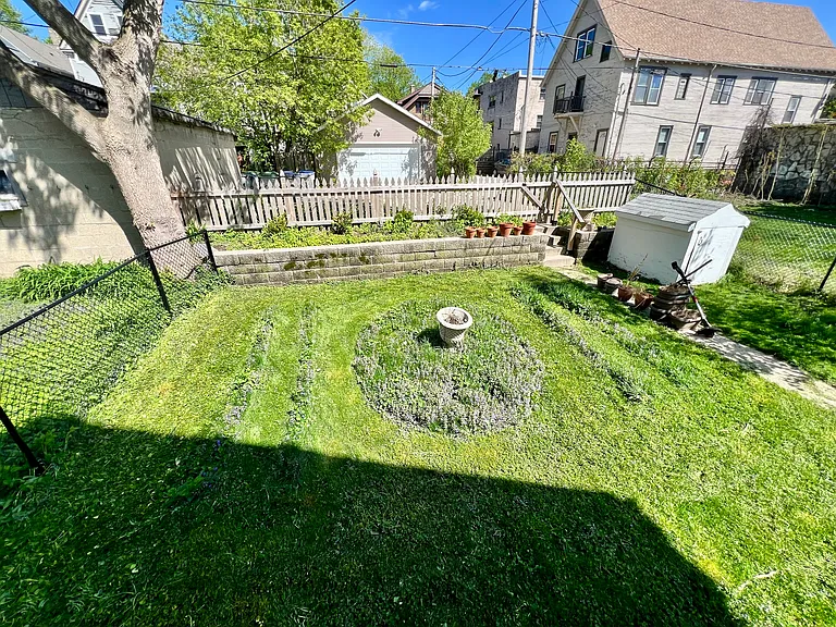 fully fenced yard. backyard overlooked by primary bedroom and deck. photo from 2024