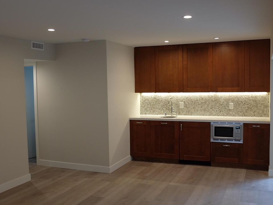 Kitchenette with microwave/convection oven, portable induction cooker, dishwasher, and refrigerator
