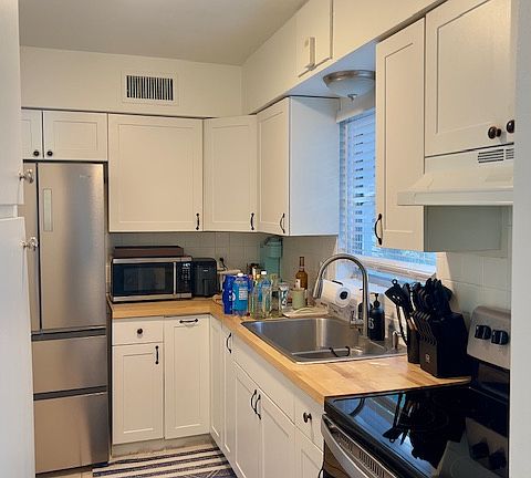 Kitchen with butcher block countertops and new stainless steel appliances