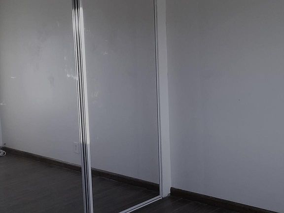 bedroom with mirror closet doors