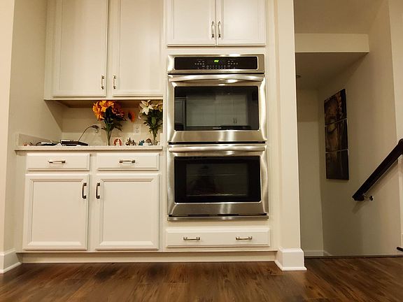 View Opposite to kitchen(Cabinets , ovens, Pantry on the right side). Left side door to powder room