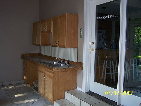 Sunroom has tile and a wetbar. Great for backyard partys!