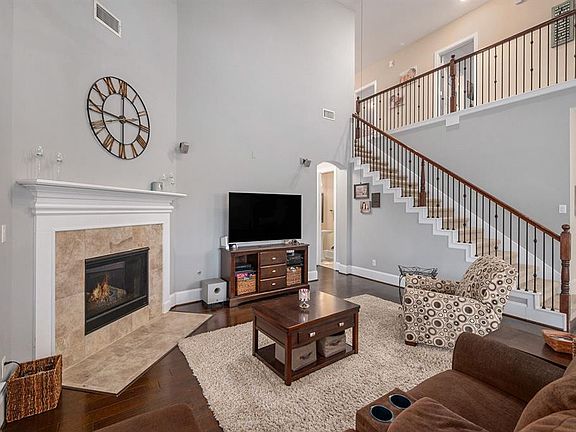 Open Floorplan with High Ceilings in Living Area Which Includes Gas Log Fireplace. Speakers are Excluded