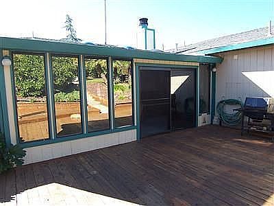 SUN ROOM OVERLOOKING WRAP-AROUND DECKING