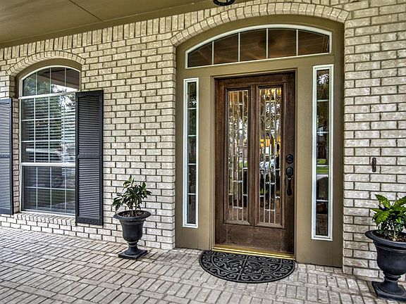 Glass leaded, wood door with side lights and transom window.