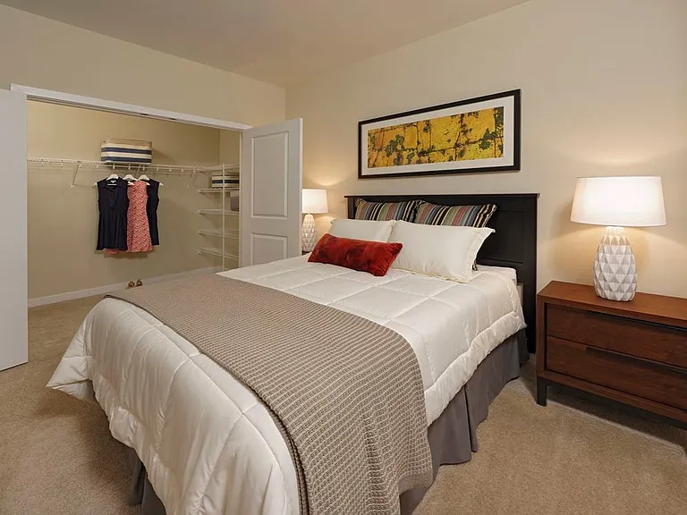Bedroom with carpeted flooring and walk-in closet
