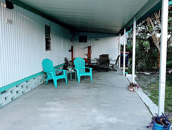 Very spacious carport with a large shed/laundry room.