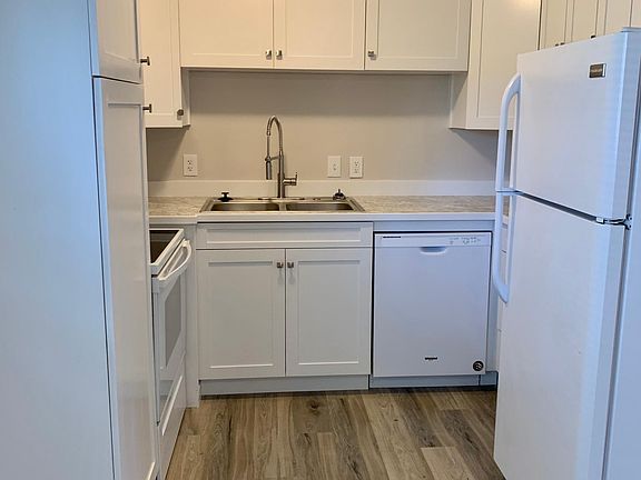 New kitchen with new dishwasher, microwave, oven, sink, and lots of cabinet space.