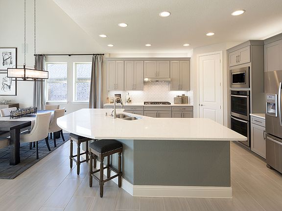 A huge center island and plenty of storage make this kitchen a chef s dream
