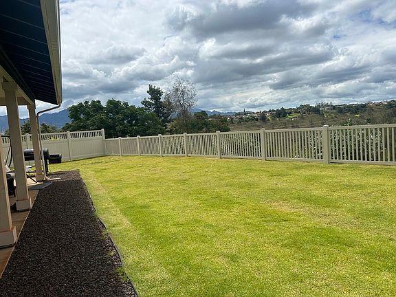 Fenced in backyard and fresh landscaping