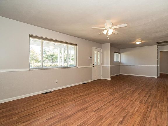The Living Room and Dining Room have beautiful laminate wood flooring and a new lighting/ceiling fan.