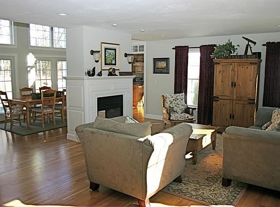 Living room has two sided gas fireplace that is shared with dining room