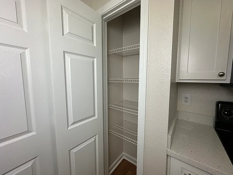 Charming pantry with ample shelving and modern cabinetry, perfect for organized kitchen storage. Charming pantry with ample shelving and modern cabinetry, perfect for organized kitchen storage.
