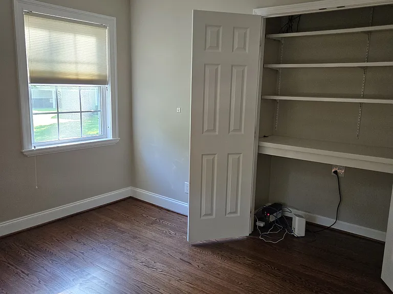 Office with built-in shelves, work area, and extra outlets for charging devices