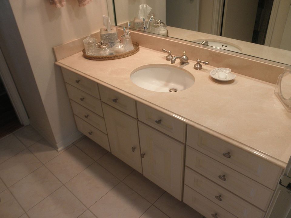 Master bath with recent marble top vanity, fixtures and tile.