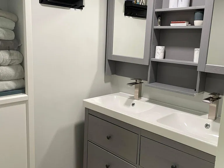 Lower Level Bathroom boasts a custom tile shower and double sinks.
