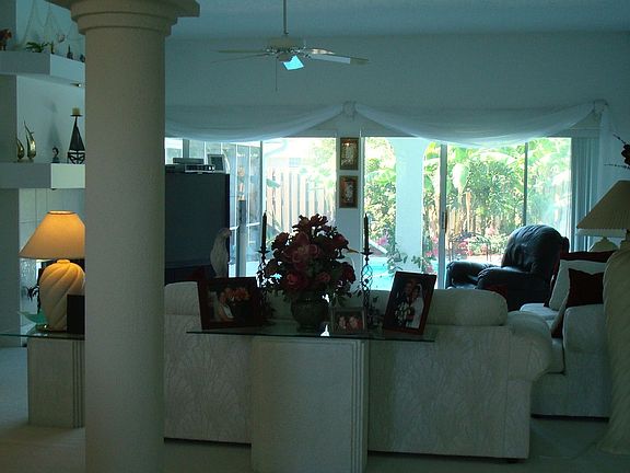 Large open living area with double mantel and columns