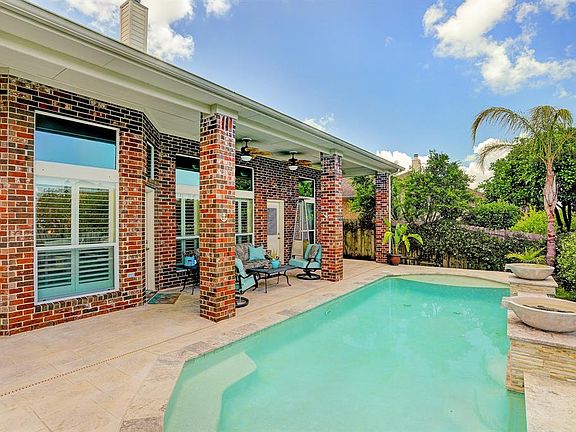 JUST IN TIME FOR THE SUMMER - RELAX IN THE POOL AND OUTDOOR COVERED AREA.