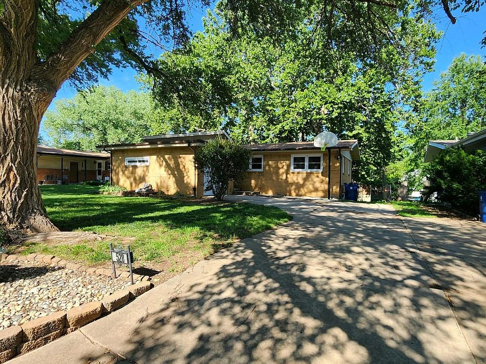 Front of house plus attached garage and basketball goal.