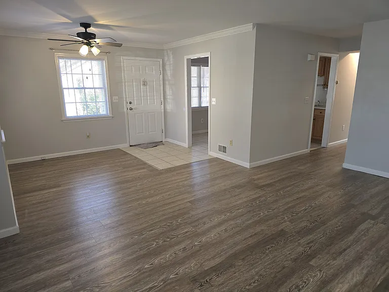 Living room looking into dining room and hallway to bedrooms and kitchen