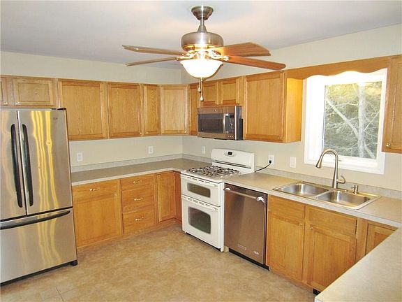 Kitchen has nice wood cabinets and ceramic tile floors! Stove is a Propane Gas and Appliances to Remain!