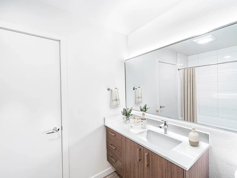 A bright bathroom with a streamlined vanity, integrated lighting, and clean finishes that create a fresh, uncluttered feel.
