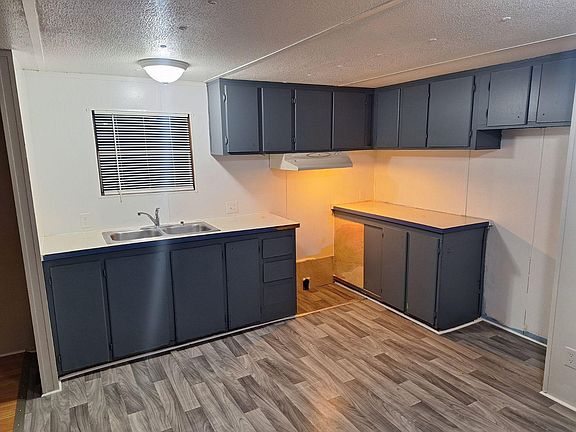 Kitchen with new flooring. Glass top stove and refrigerator to be installed prior to move in.