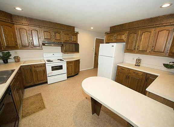 Kitchen with newer stove and refrigerator.