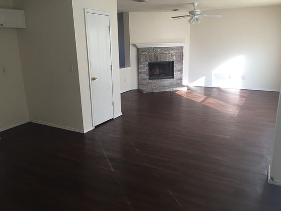 Open concept kitchen to family room with ceiling fan