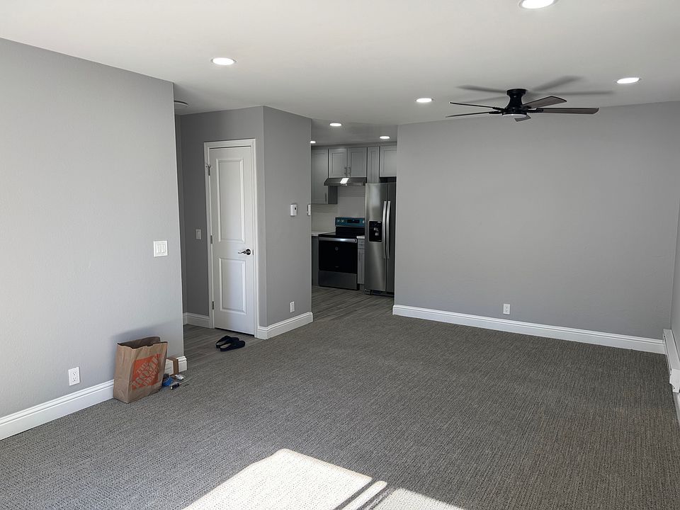 Living Room & Dining Area. See new carpet, paint, fan, baseboards.