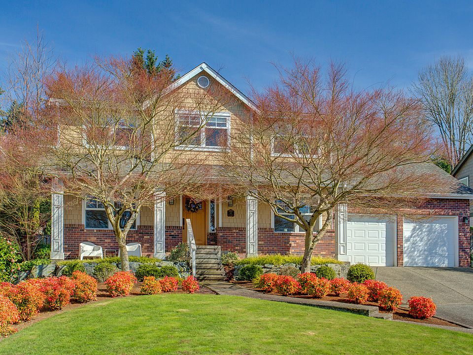Stately white columns and a well-planned landscape welcome y