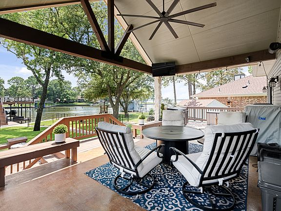 Covered porch with ceiling fan with round table and seating for 4.