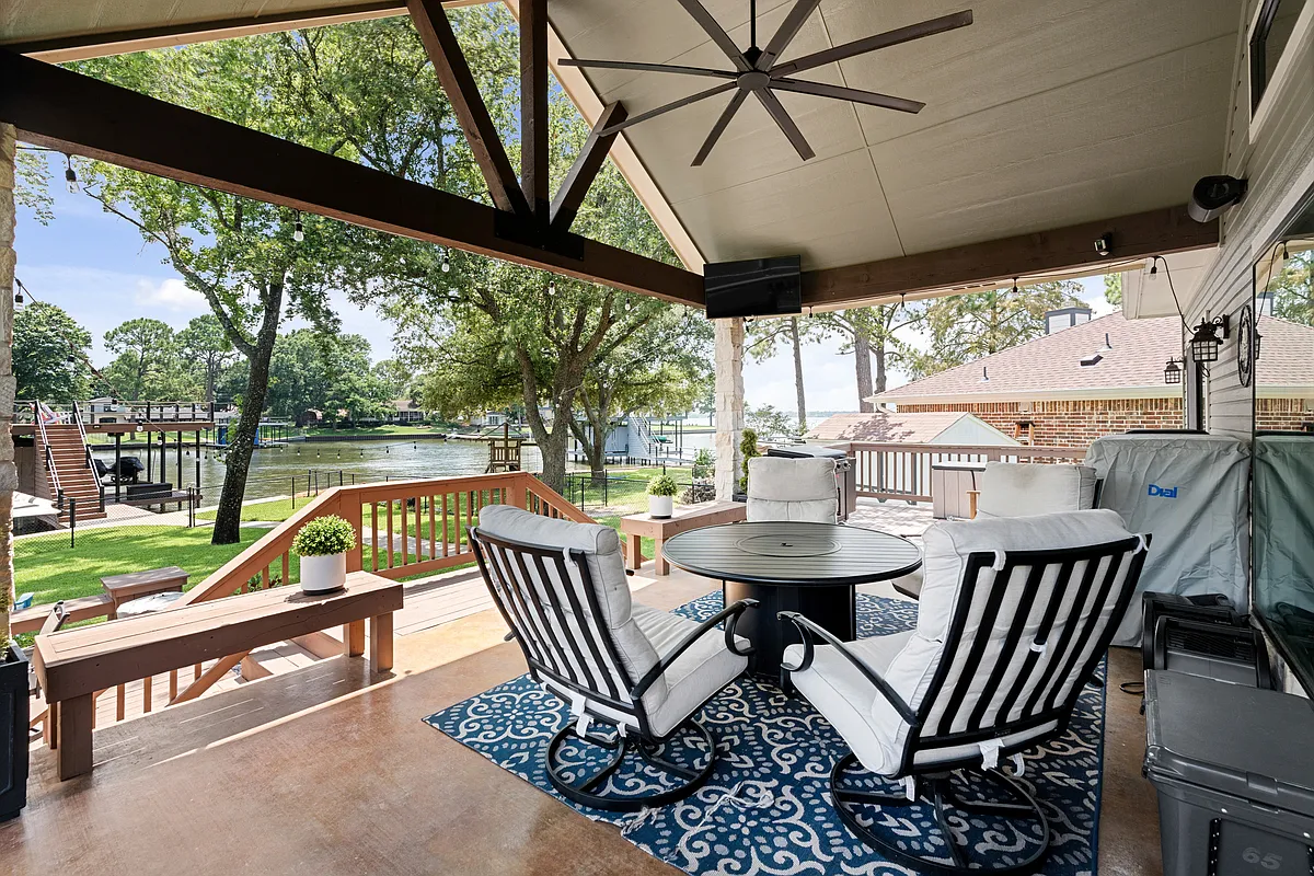 Covered porch with ceiling fan with round table and seating for 4. - 120 Excalibur Cir
