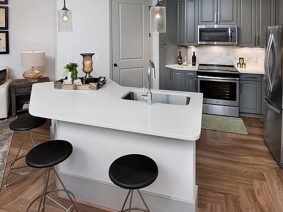 Chef-inspired kitchens feature granite and courtz countertops and stainless steel appliances