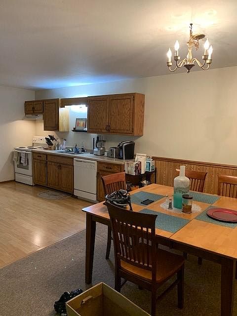 Open concept kitchen and dining room with wood laminate floor for easy clean up.