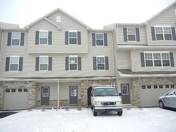 Front (White truck parked in the driveway) - middle door house