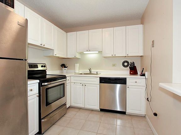 Stainless Steel appliances, nice size kitchen, breakfast bar- Paint color is now gray tones with new lighting in kitchen