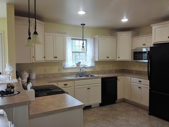Kitchen overlooking rear of house and back deck