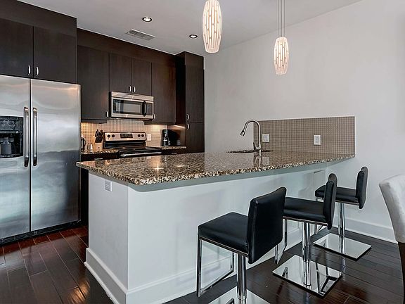 Upgraded kitchens with granite countertops and stainless steel appliances