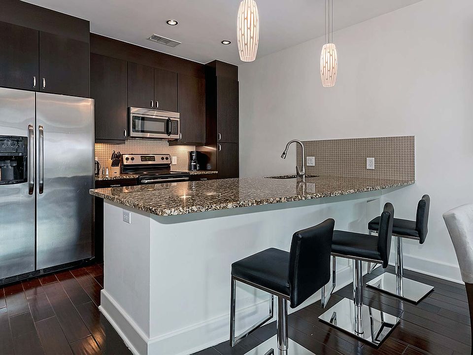 Upgraded kitchens with granite countertops and stainless steel appliances