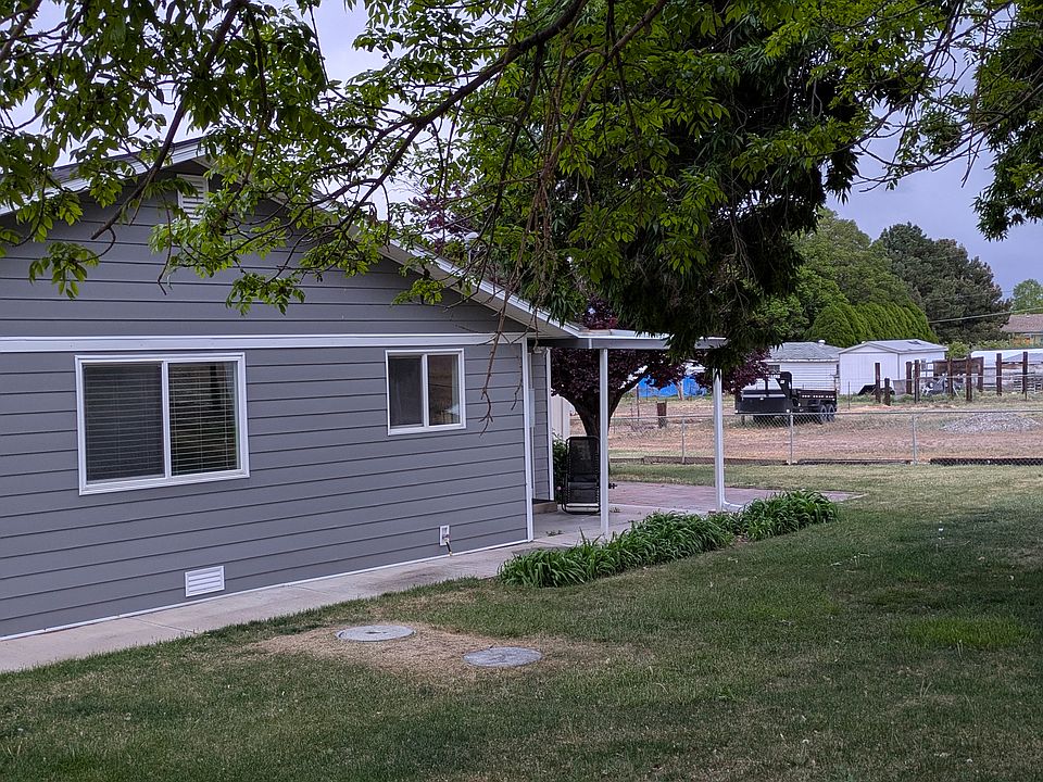 This is the tenant fenced yard with grass and 3 mature trees. There is a covered patio off the rear sliding doors.